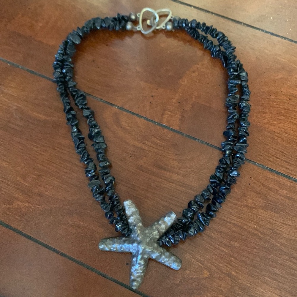 Black beaded multi-strand necklace with bronze colored starfish